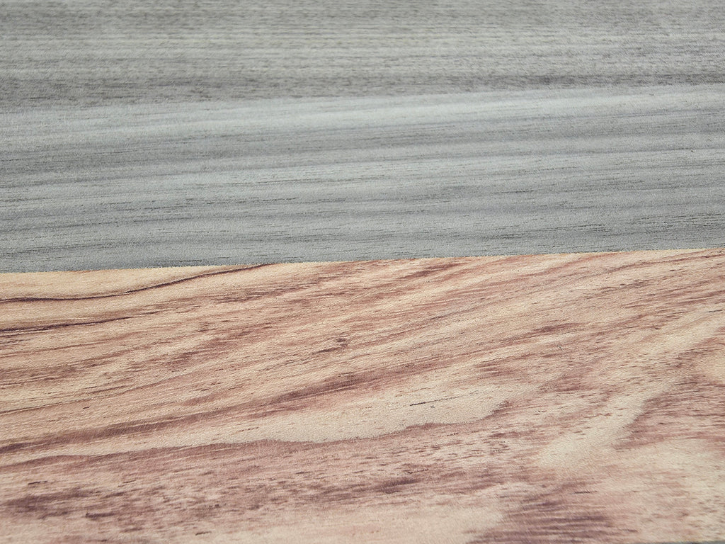 Close up of walnut and pink ivory wood grain on luxury cheese board