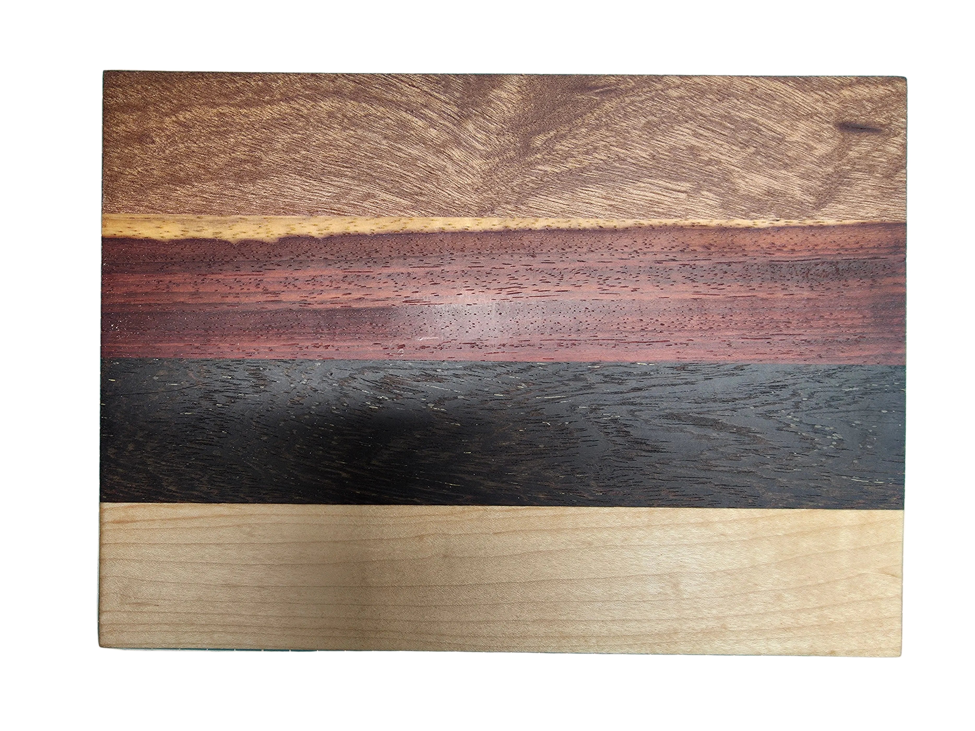 Close up of oak black palmwood pink ivory and kiaat wood grain on cheese board