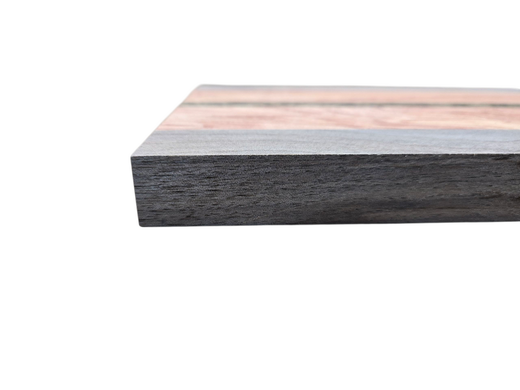 Walnut pink ivory and black palmwood cheese board displayed in kitchen setting
