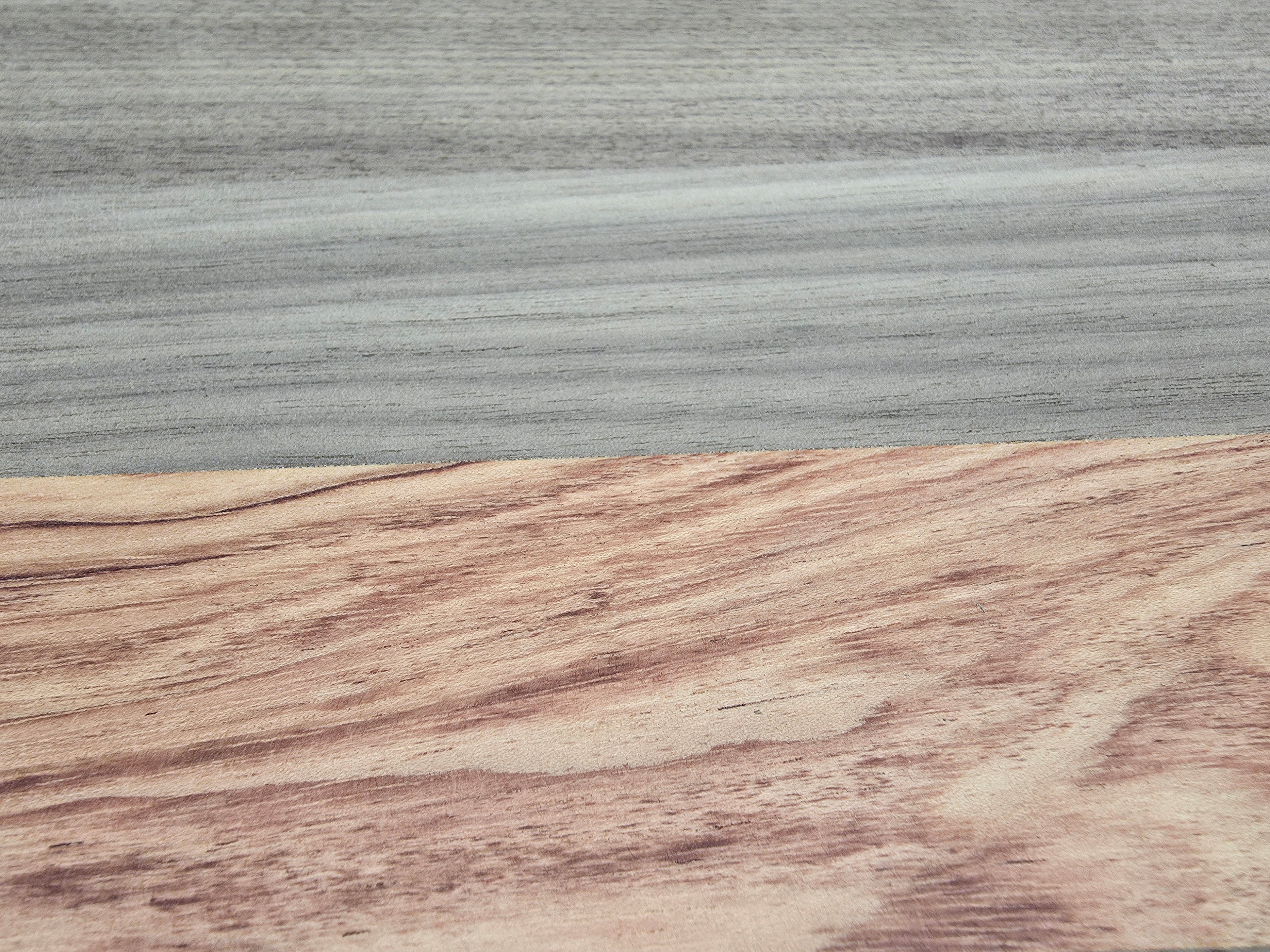 Close up of walnut and pink ivory wood grain on chopping board