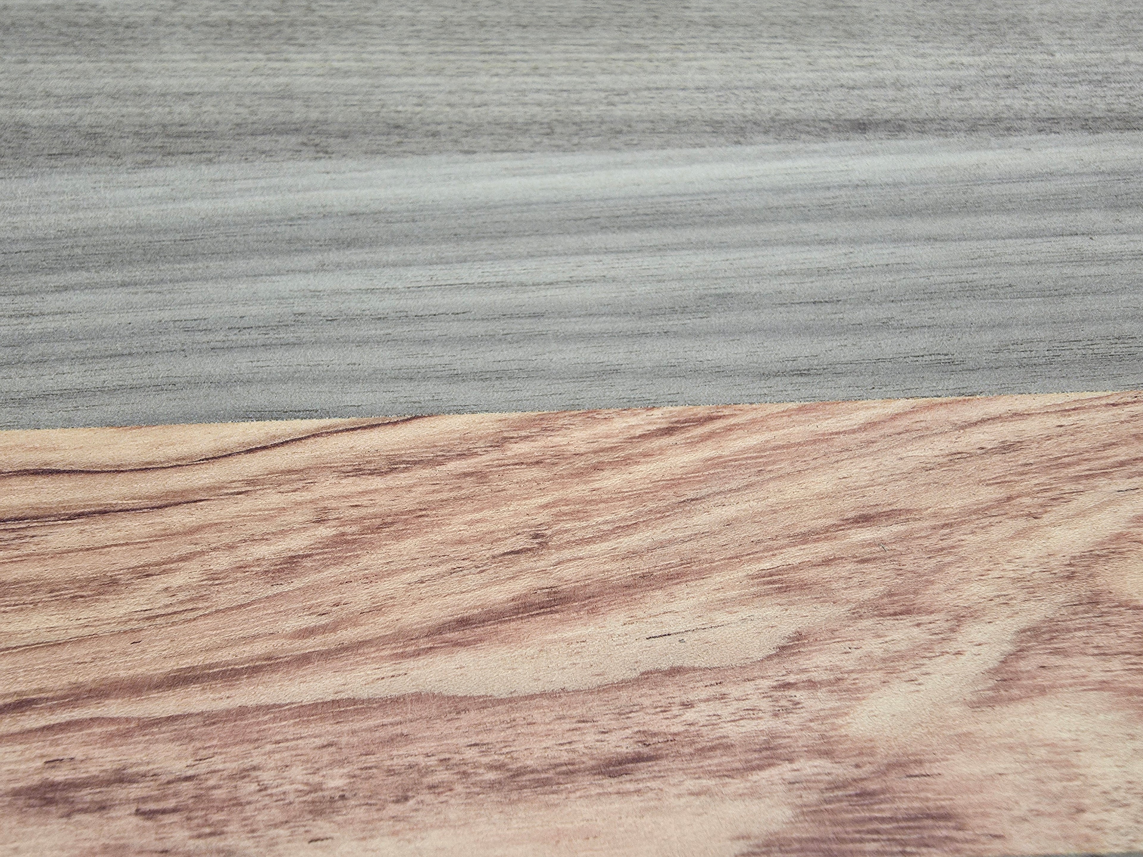 Close up of walnut and pink ivory wood grain on chopping board