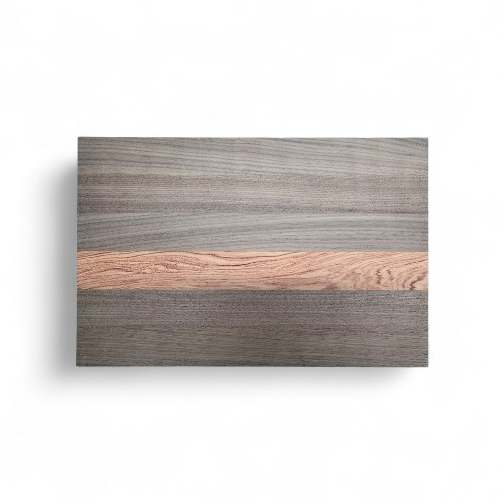 Walnut and pink ivory chopping board in use preparing food in kitchen